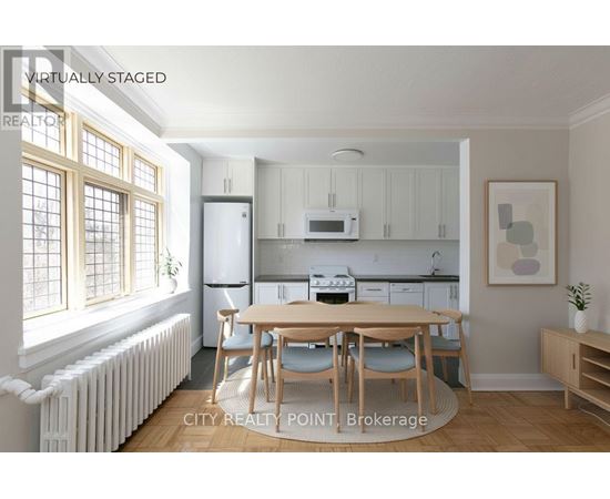 A kitchen with a table and chairs in the middle of the room.