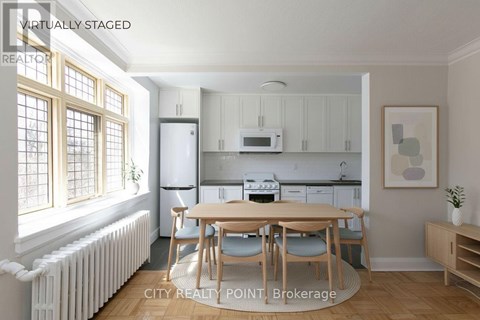 A kitchen with a table and chairs in the middle of the room.