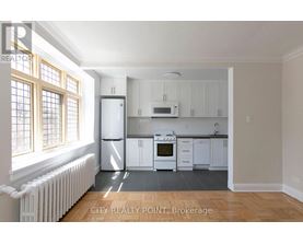 A kitchen with white appliances and cabinets is shown.