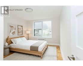 A bedroom with a bed, nightstand, and lamp.