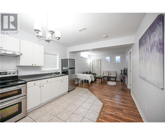A kitchen with white cabinets and a dining table.