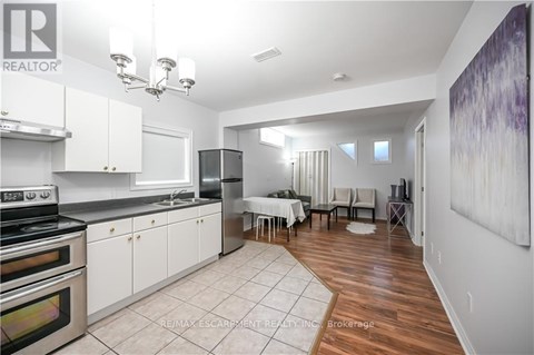 A kitchen with white cabinets and a dining table.