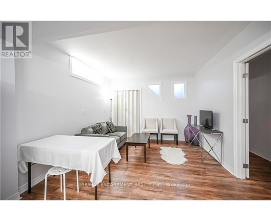 A living room with a white table and chairs.