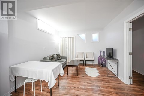 A living room with a white table and chairs.