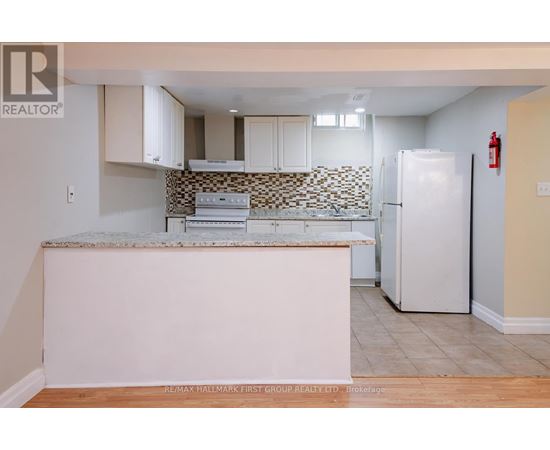 A kitchen with a white fridge and a counter top.