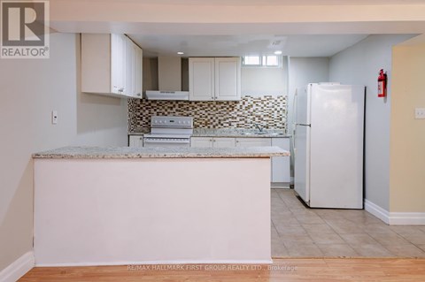 A kitchen with a white fridge and a counter top.
