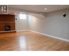 A room with a fireplace and wooden floors.