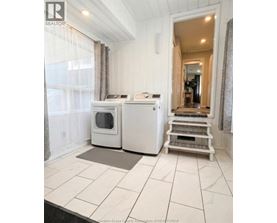A white kitchen with a microwave and oven.