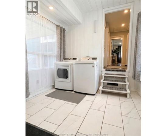 A white kitchen with a microwave and oven.
