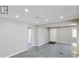 A spacious room with a marble floor and white walls.
