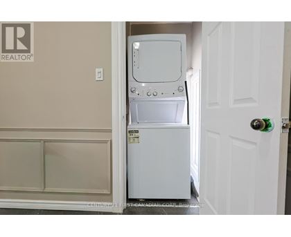 A white dishwasher is in a small kitchen.