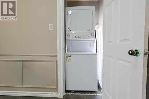 A white dishwasher is in a small kitchen.
