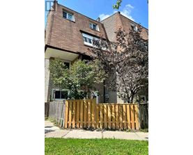 A brown building with a wooden fence in front of it.