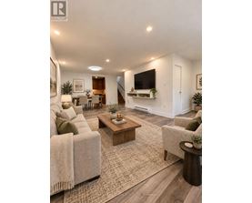A living room with a couch, a coffee table, and a television.