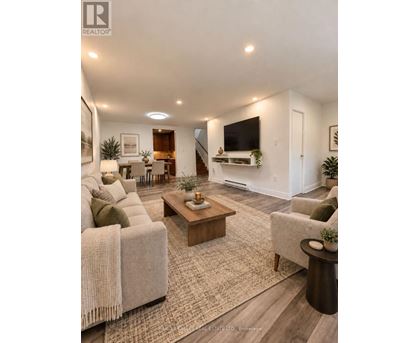 A living room with a couch, a coffee table, and a television.