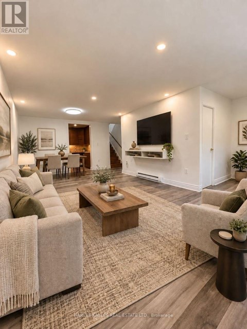 A living room with a couch, a coffee table, and a television.