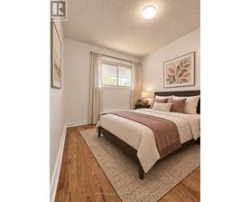 A bedroom with a large bed and a window with curtains.