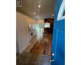 A blue door is on the right side of a hallway.