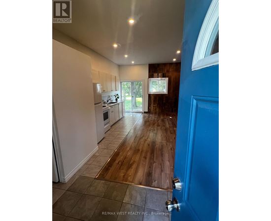 A blue door is on the right side of a hallway.