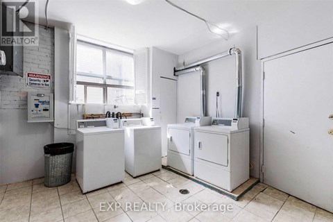 A bathroom with a white sink and a white toilet.