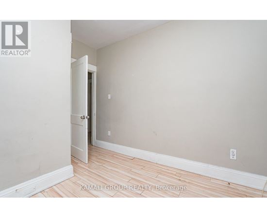 A room with a wooden floor and a white door.