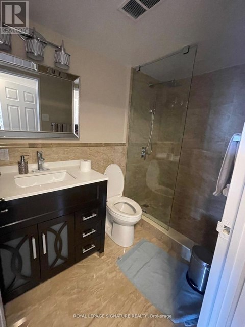 A bathroom with a sink, toilet, and shower.