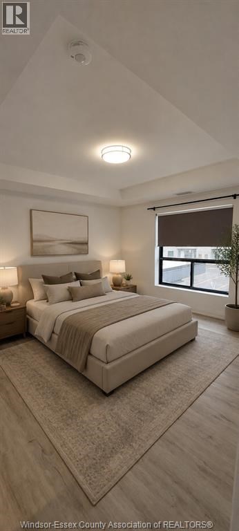 A well-lit bedroom with a large bed and a window.