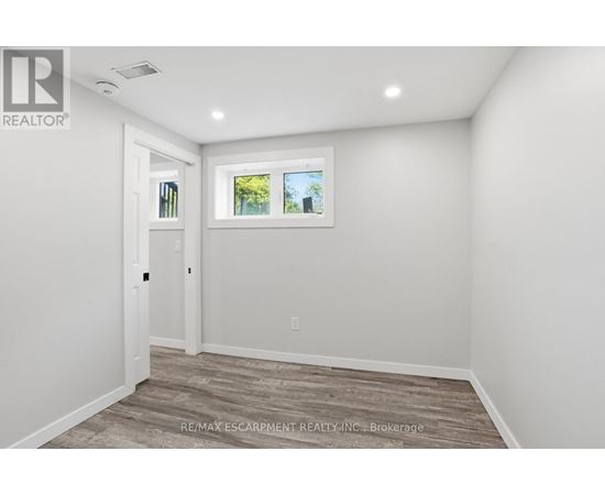 A room with a window and a door.