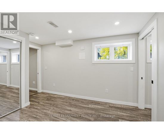 A room with a window showing trees outside.