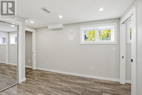 A room with a window showing trees outside.