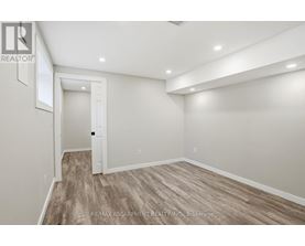 A room with a wooden floor and white walls.