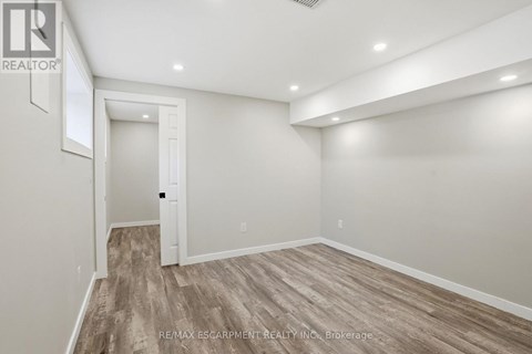 A room with a wooden floor and white walls.