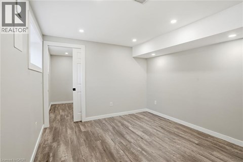 A room with wood flooring and white walls.