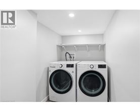 Two front load washing machines in a laundry room.