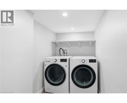 Two front load washing machines in a laundry room.