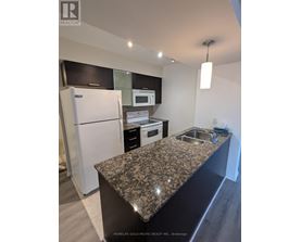 A kitchen with granite countertops and stainless steel appliances.