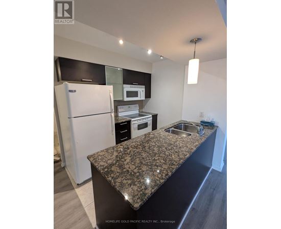 A kitchen with granite countertops and stainless steel appliances.