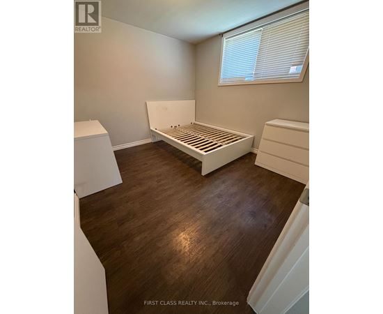 A bedroom with a bed, dresser and nightstand.