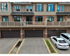 A car is parked in front of a garage door.