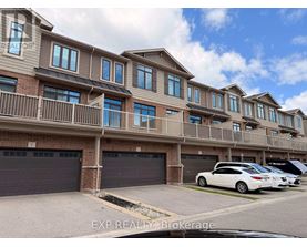 A row of townhouses with a car parked in front.