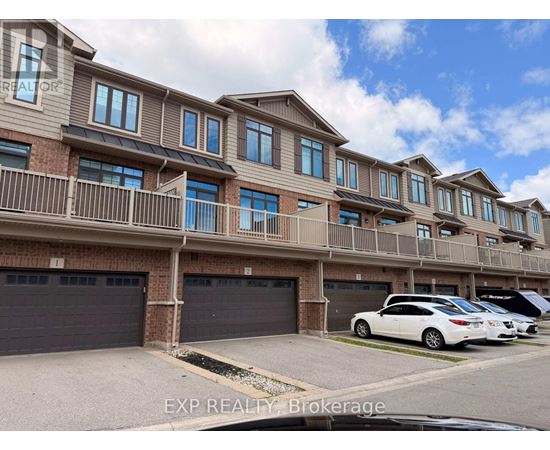 A row of townhouses with a car parked in front.