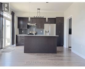 A kitchen with dark brown cabinets and a large island.