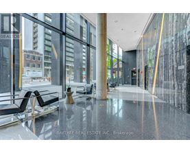 A Baytree Real Estate Inc. brokerage office with a glass wall and black chairs.