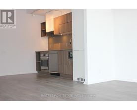 A modern kitchen with wooden cabinets and a stainless steel oven.