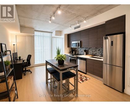 A modern kitchen with a dining table and chairs.