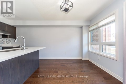 A kitchen with a sink and a window.