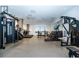 A spacious gym with a variety of equipment including treadmills, weights, and exercise machines.