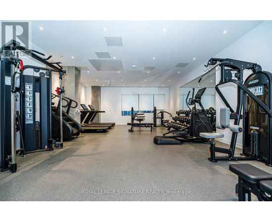 A spacious gym with a variety of equipment including treadmills, weights, and exercise machines.