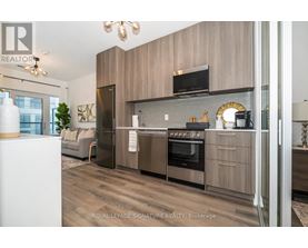 A modern kitchen with wooden cabinets and stainless steel appliances.