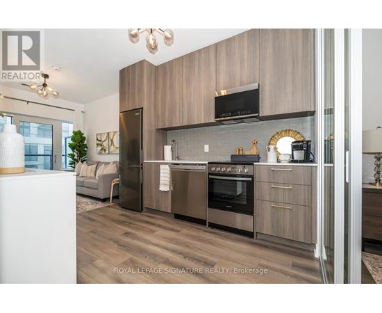 A modern kitchen with wooden cabinets and stainless steel appliances.